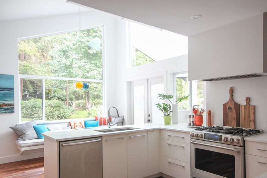 white modern kitchen with large window, turquoise and orange accents, 